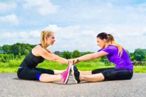 שתי נשים עושות מתיחות לרגליים